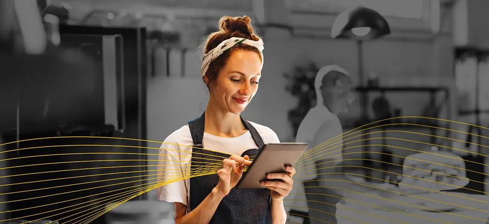 Two people working with a computer and a notepad fulfilling an order