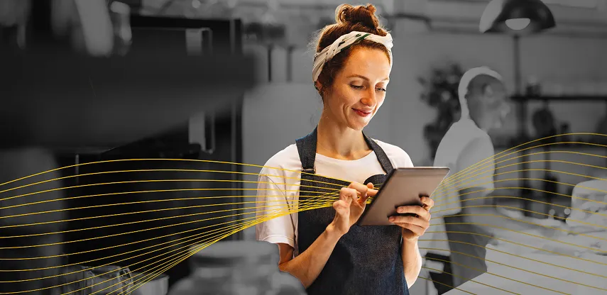 Two people working with a computer and a notepad fulfilling an order