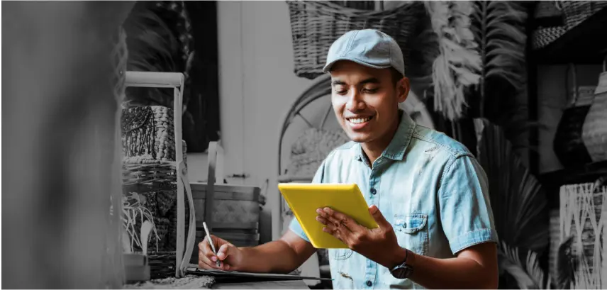 Man holding a tablet in a store selling baskets